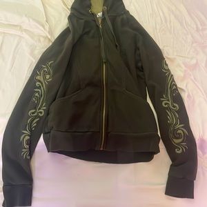 green hoodie with designs on the arms